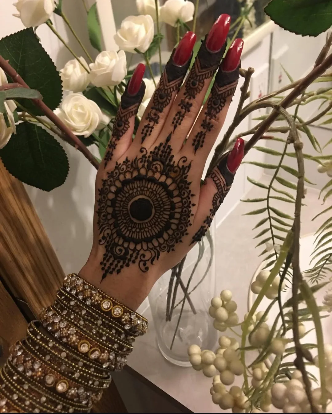 A bride's hands showing her completed bridal mehndi