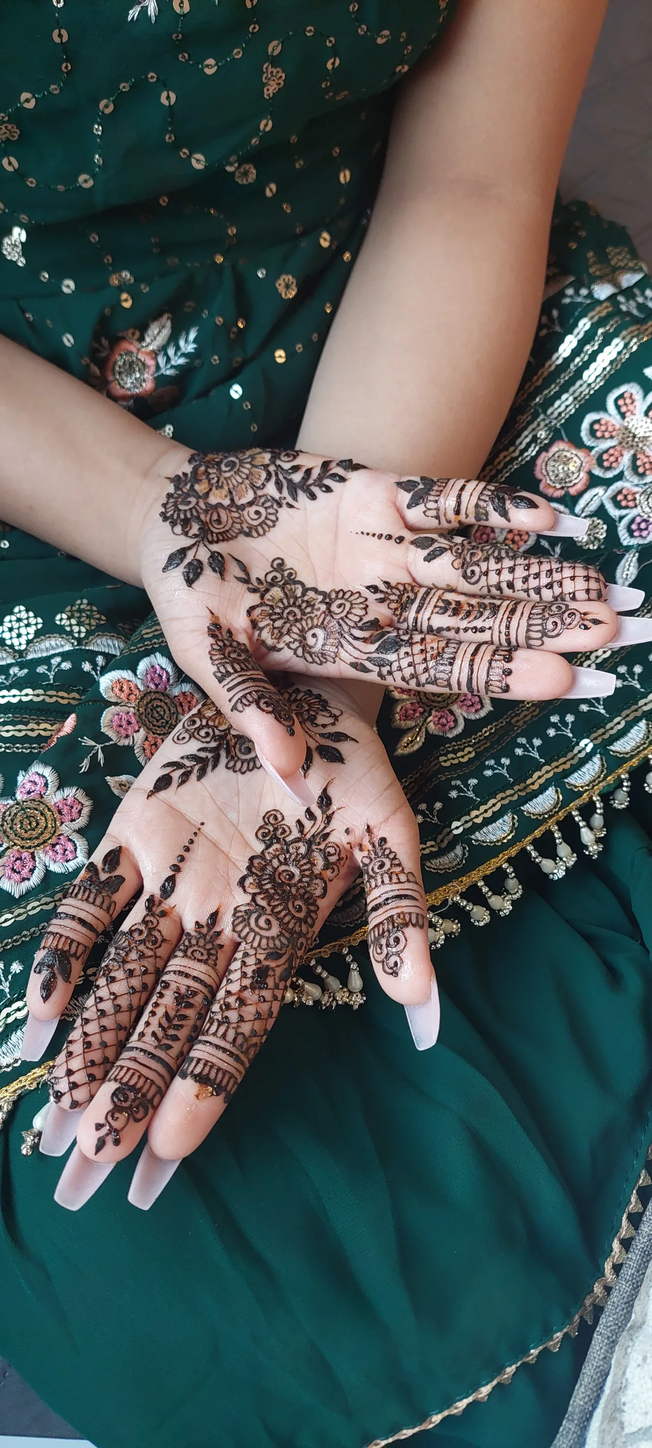 A bride's completed mehndi catching warm light