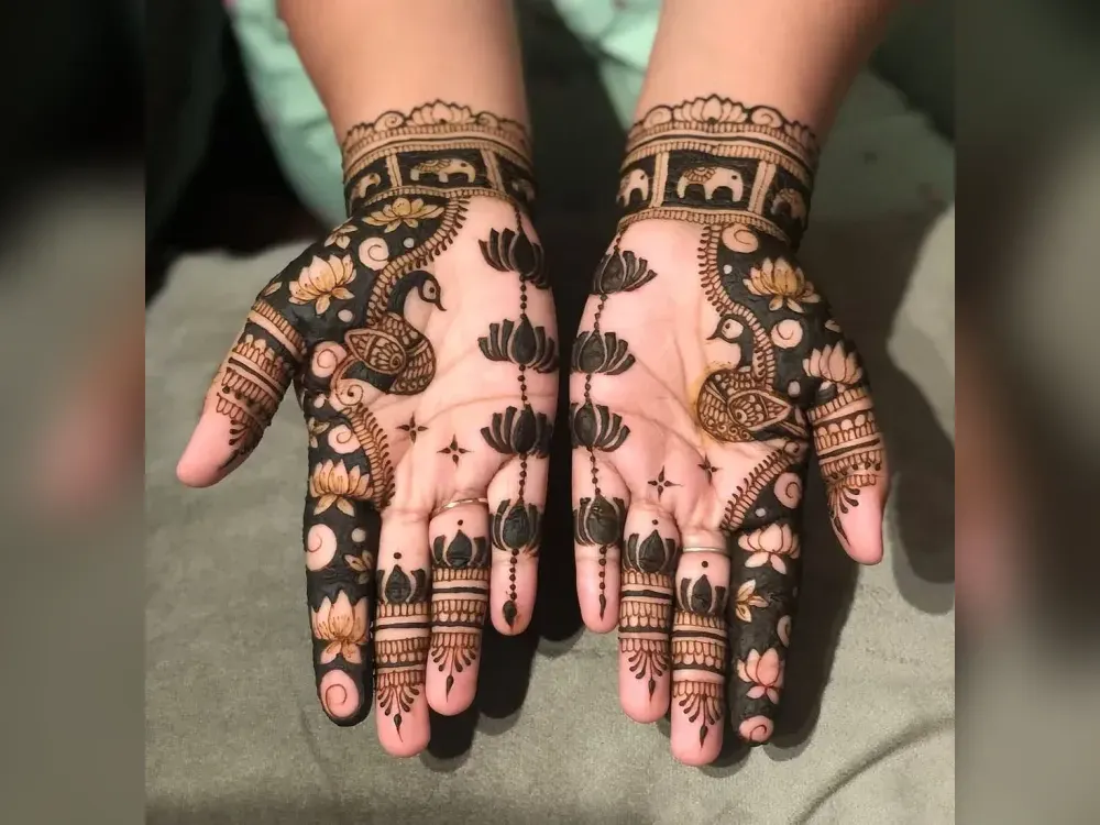 Lotus and peacock motifs in Karwa Chauth mehndi across both palms