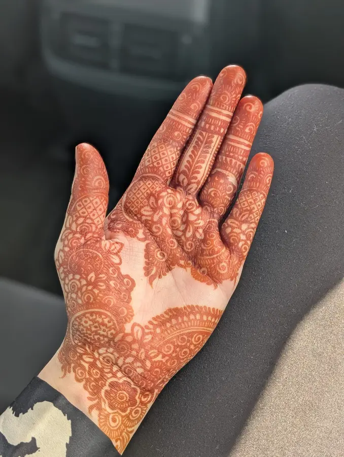 Karwa Chauth mehndi design on the palm, florals at the wrist and fingers with the centre open