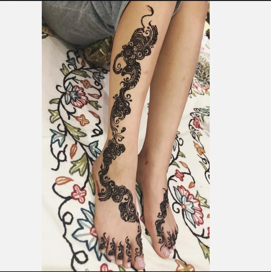 Karva Chauth henna on a guest's hands at a group session