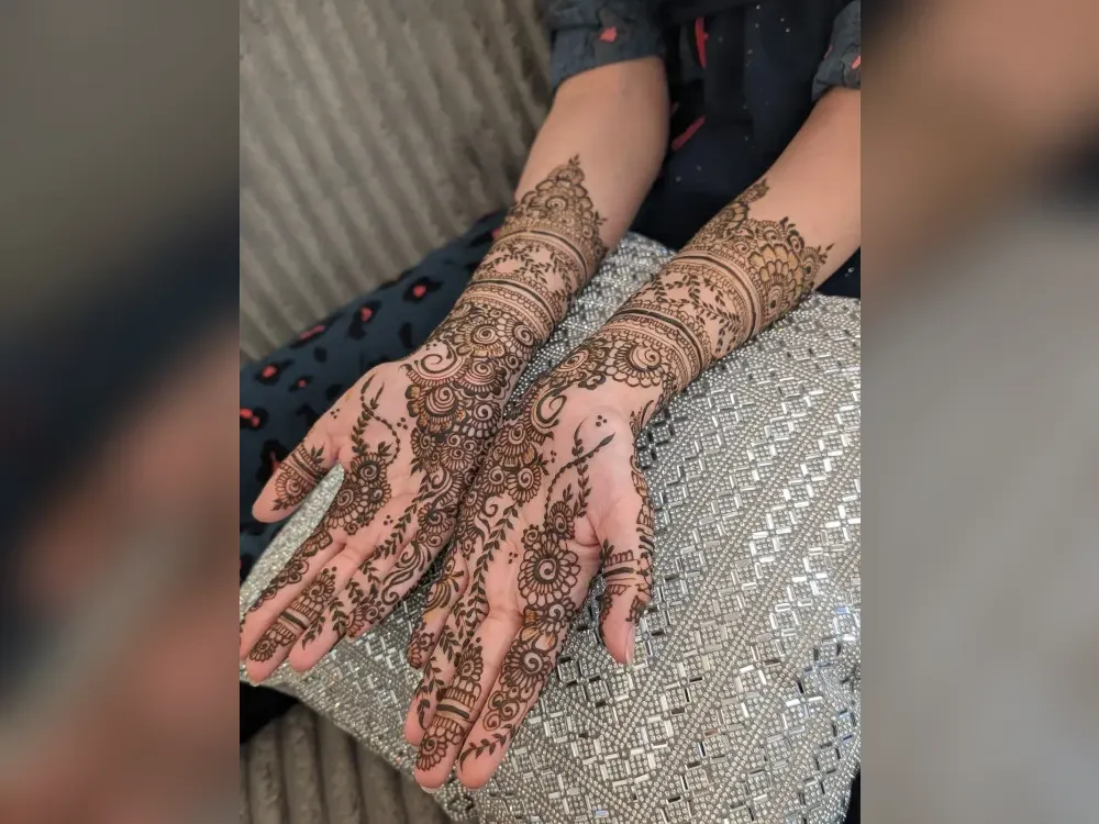 Natural henna on both hands, the warm brown stain fresh-mixed paste produces