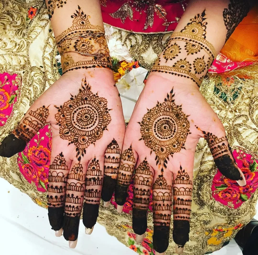 A bride's hand with a small trial henna design during a bridal mehndi trial session