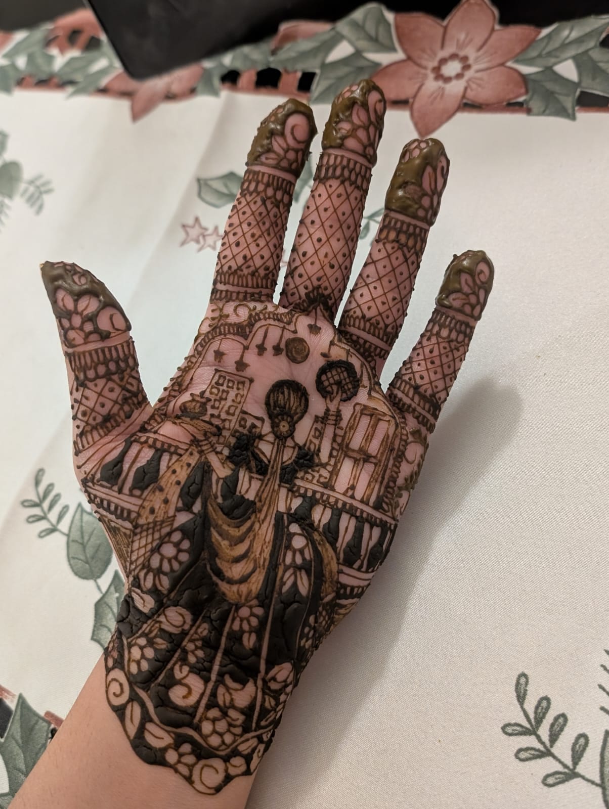 Intricate freehand henna palm design featuring a detailed dulhan and palace scene, Calgary