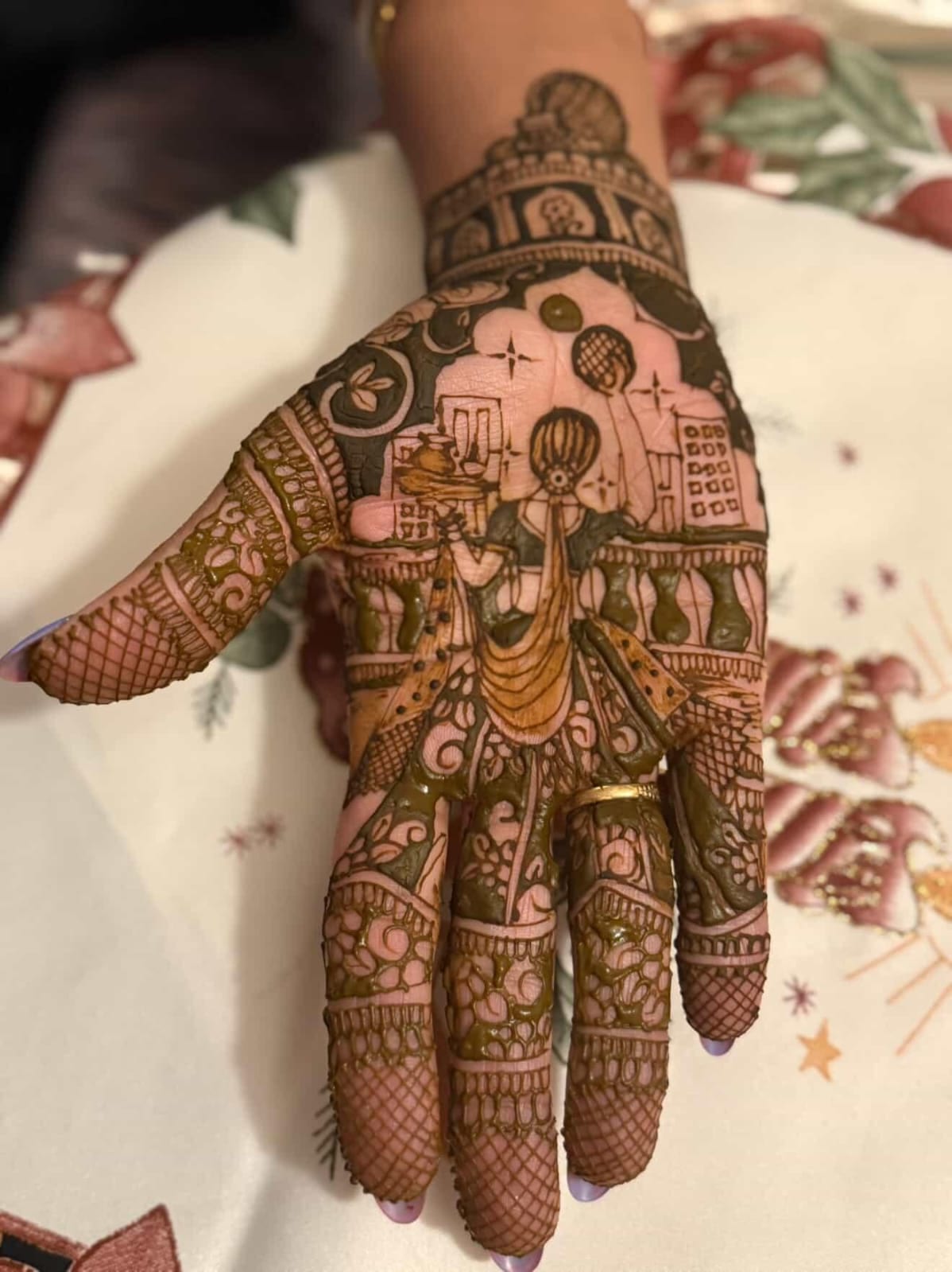 Highly detailed freehand henna art on the back of the hand with a figurative scene, Calgary