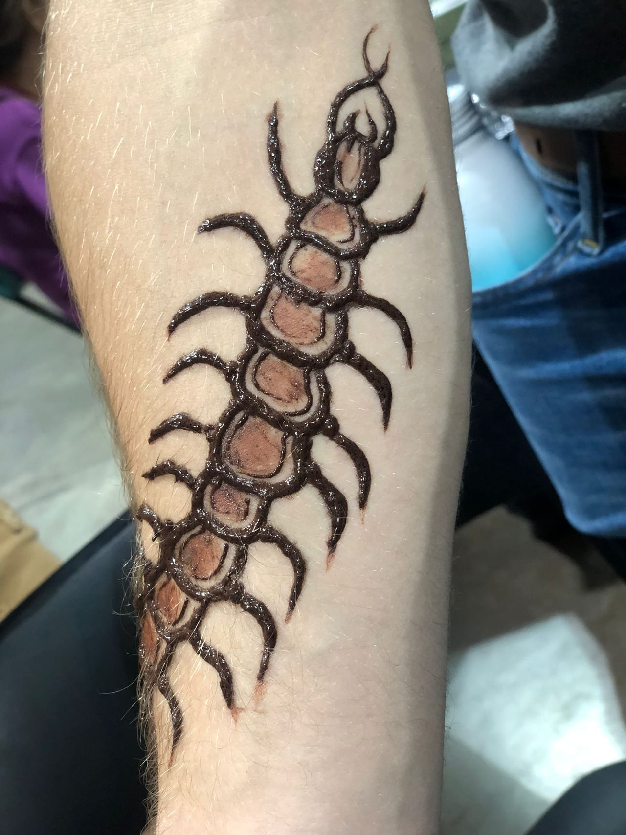 Tribal centipede henna tattoo along the forearm, Calgary