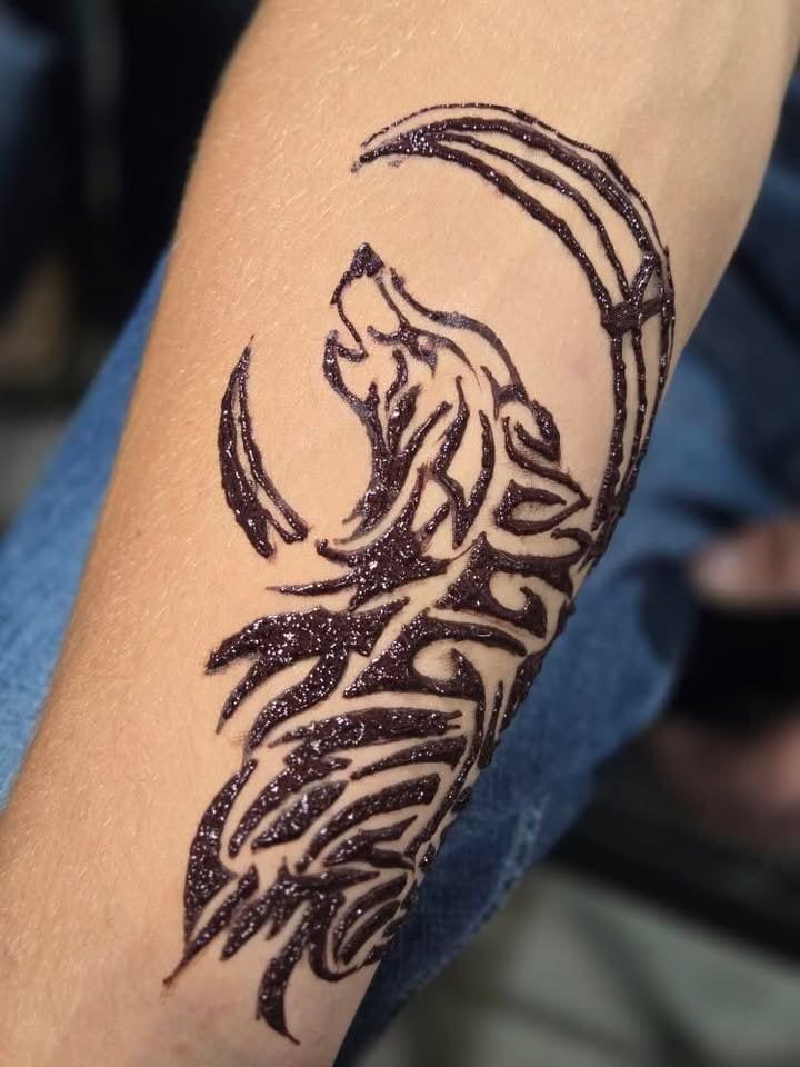 Tribal wolf henna tattoo with glitter finish on the forearm, Calgary